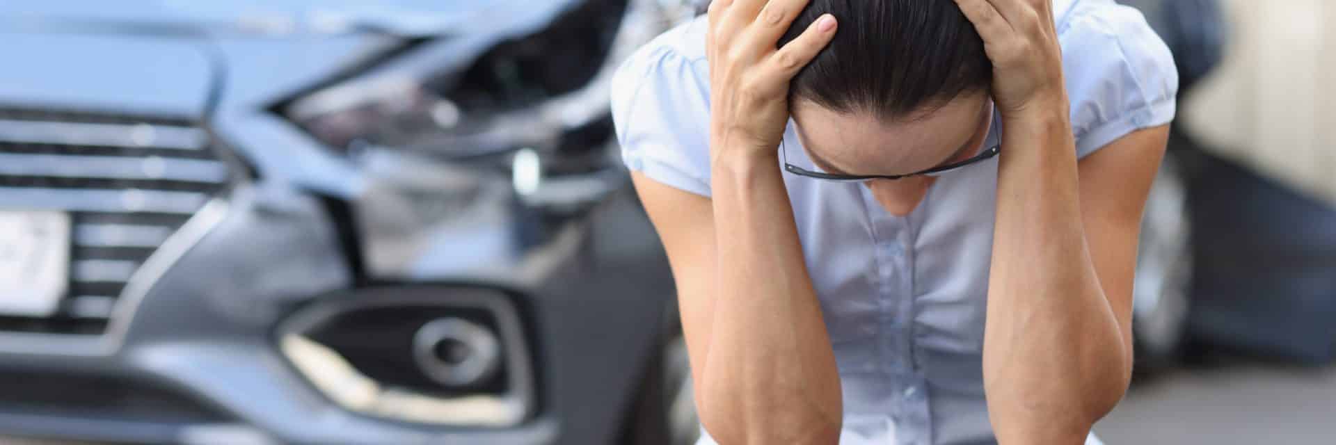 Frightened Woman Sits In Front Of Wrecked Car. Driver Stress Aft